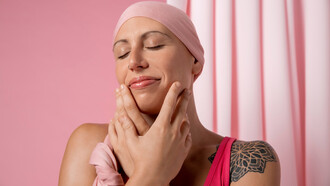 Woman recovering from breast cancer, adorned in a pink scarf