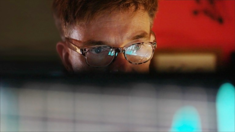 A man reading data from a computer screen