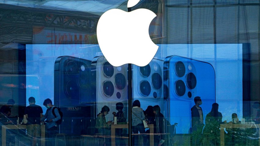 People try out iPhone products at an Apple Store in Beijing.