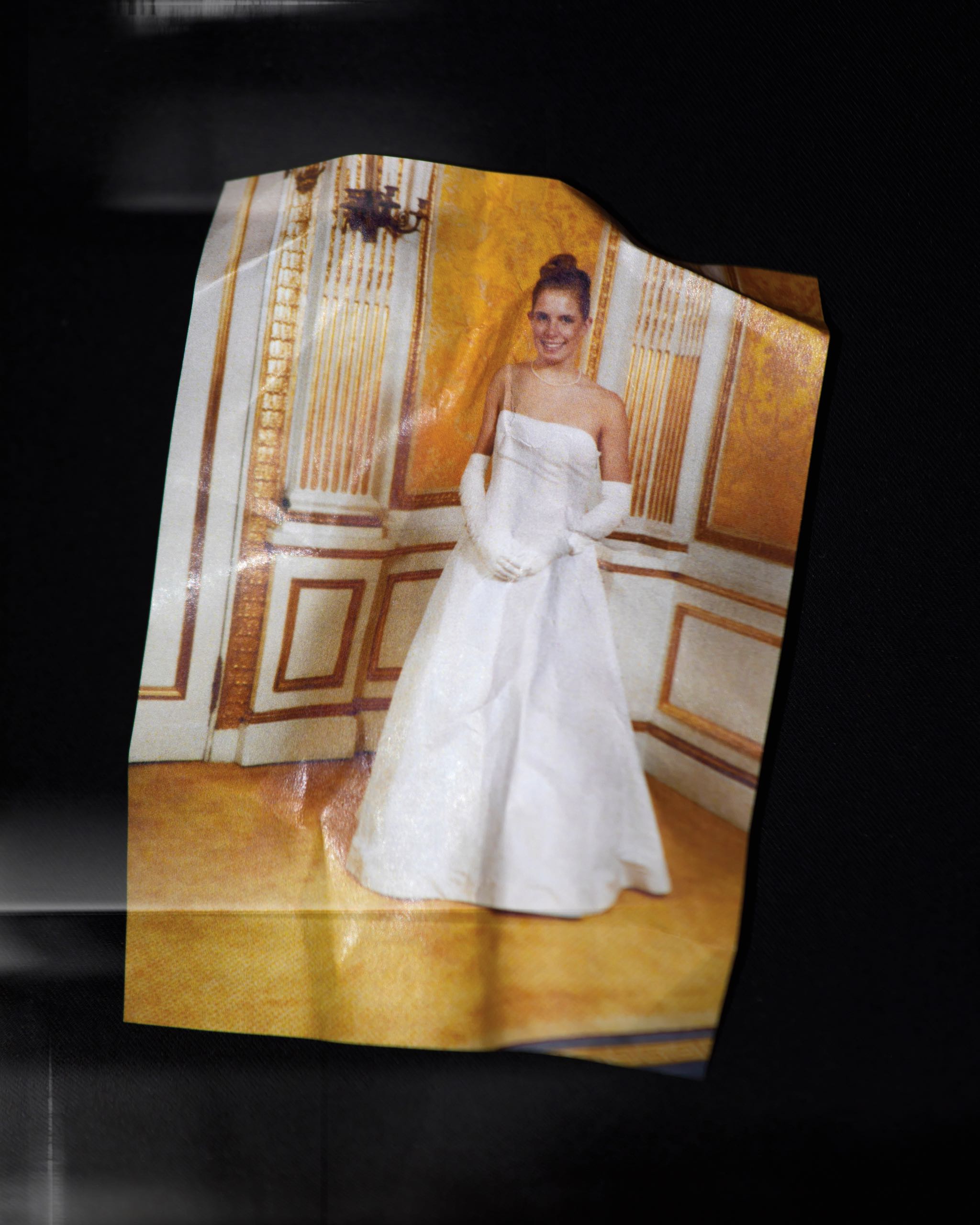 Bent image of young woman in white dress and white gloves.