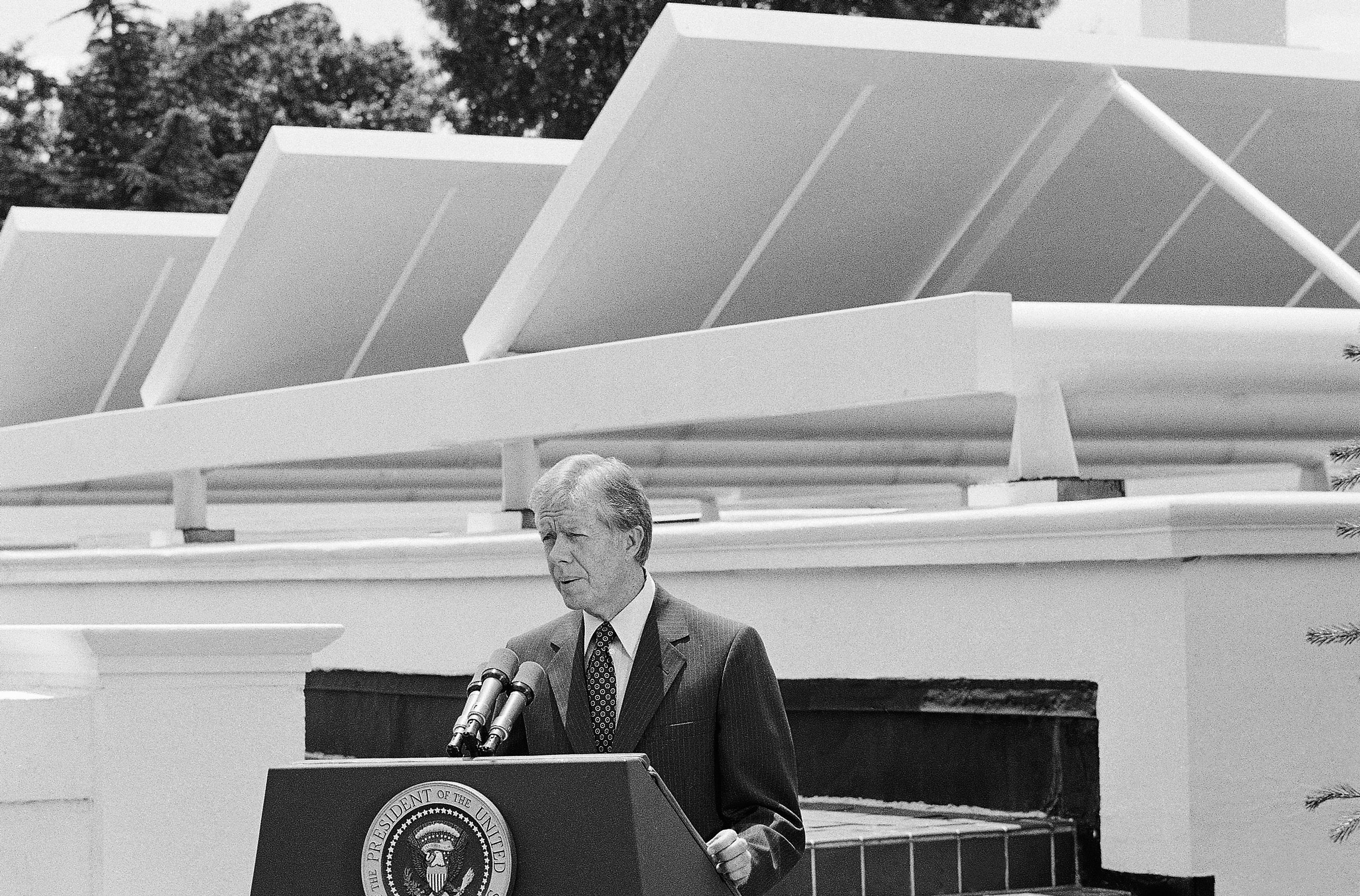 Jimmy Carter speaks in front of solar panels he installed at the White House