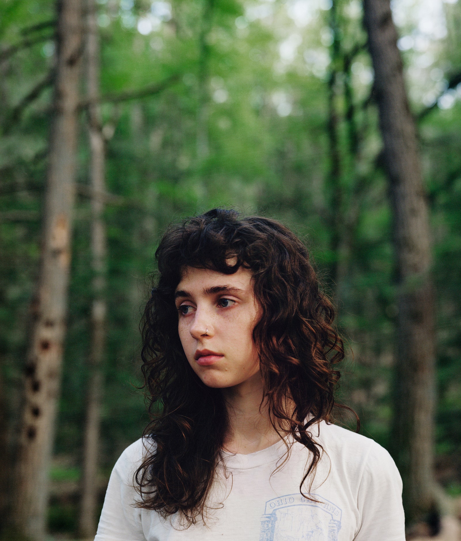 A closeup portrait of a woman outdoors.