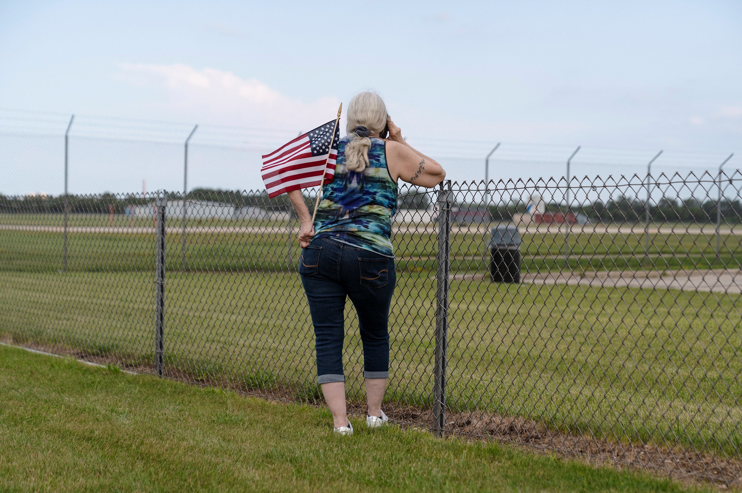 A supporter waits for Republican presidential candidate and former U.S. President Donald Trump to arrive on Trump Force...