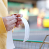 Purchased - Person holding a receipt at the grocery store