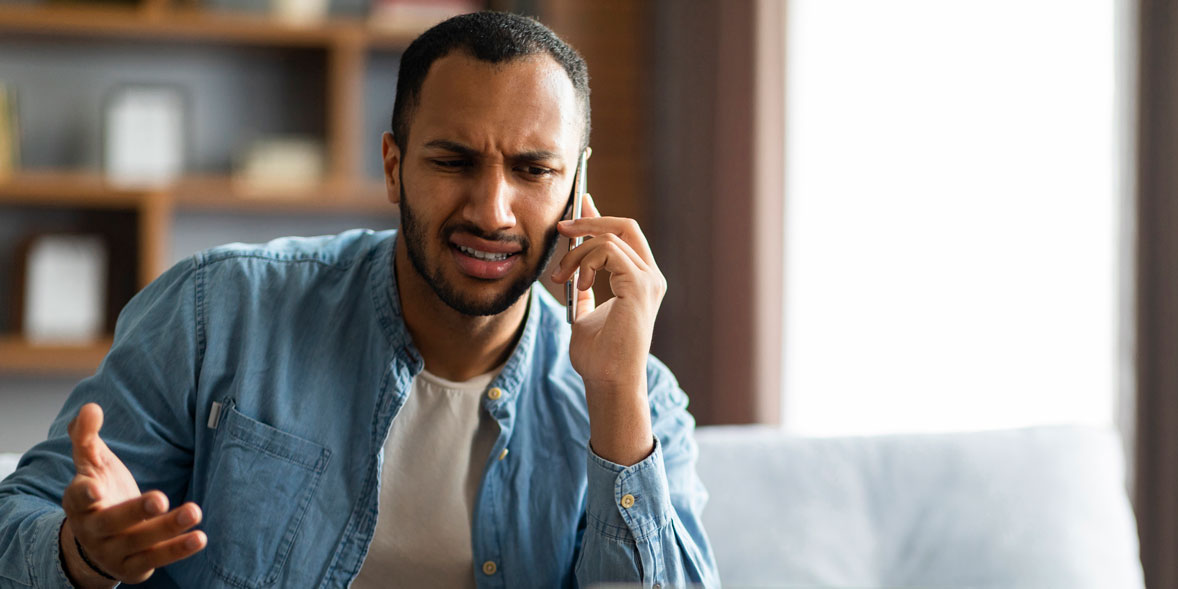 Man on phone looking frustrated