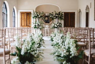 Image may contain Aisle Indoors Chair Furniture Flower Flower Arrangement and Plant