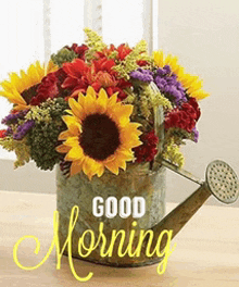 a watering can filled with flowers and the words good morning on it