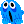 a blue ghost with big eyes and a surprised face .