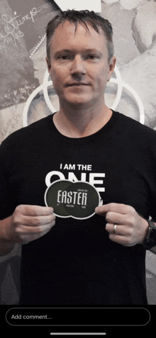 a man wearing a black t-shirt that says i am the one easter