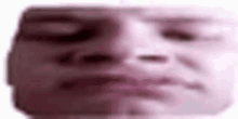 a blurry picture of a person 's face with their eyes closed and mouth open .