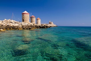 Los molinos y el faro del fuerte de Rodas .