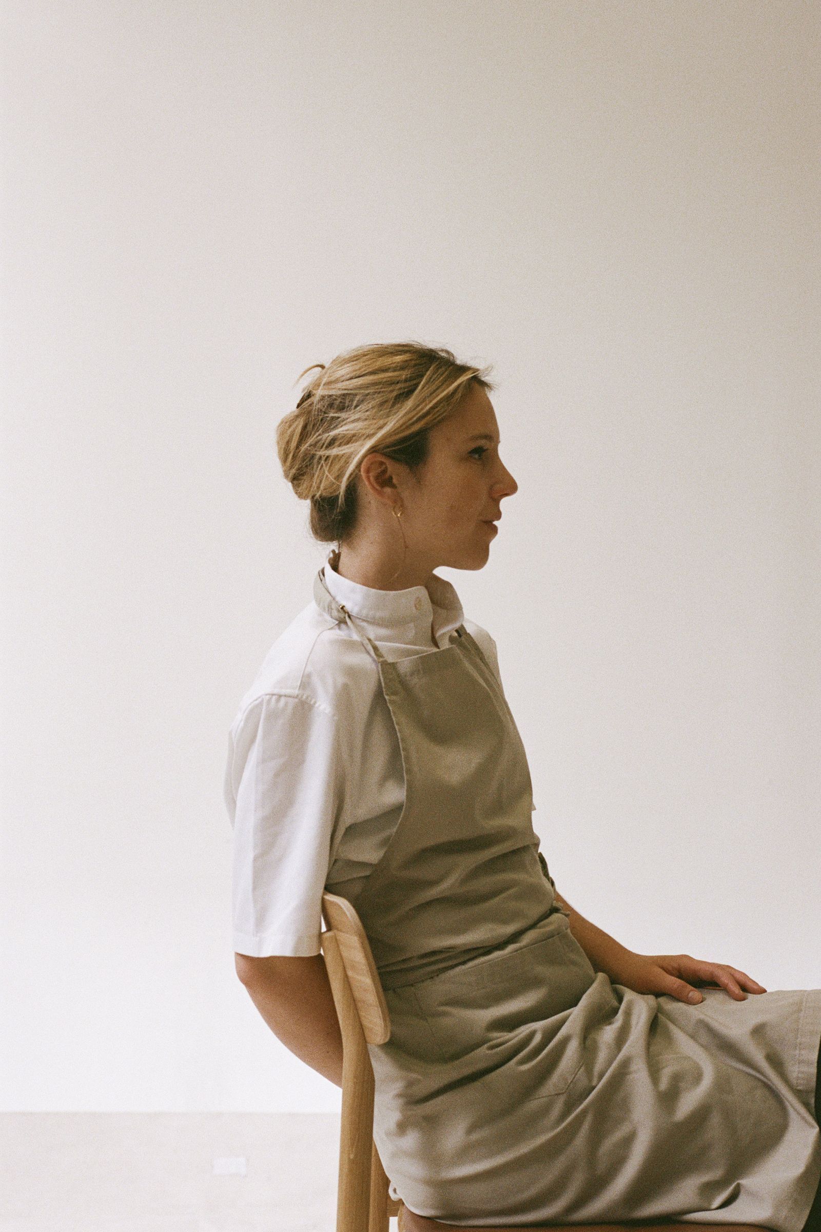 Image may contain Person Sitting Blouse Clothing Dress Face Head Photography Portrait Formal Wear and Sleeve