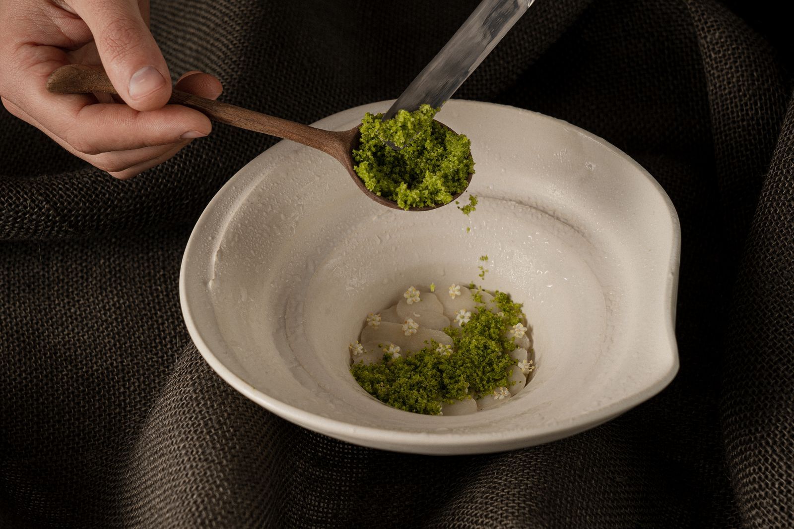 Image may contain Cutlery Spoon Plate Cooking Person and Mixing Food