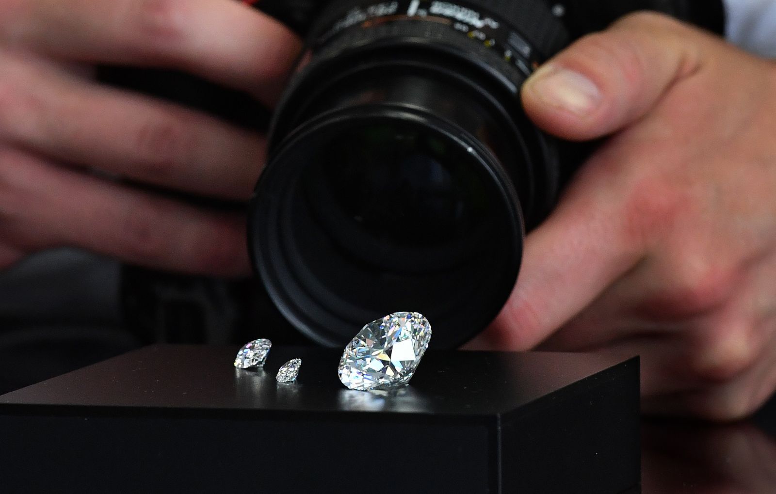 A photographer takes pictures of the main 51.38carat roundcut diamond the Dynasty and other gems from Russian diamond...