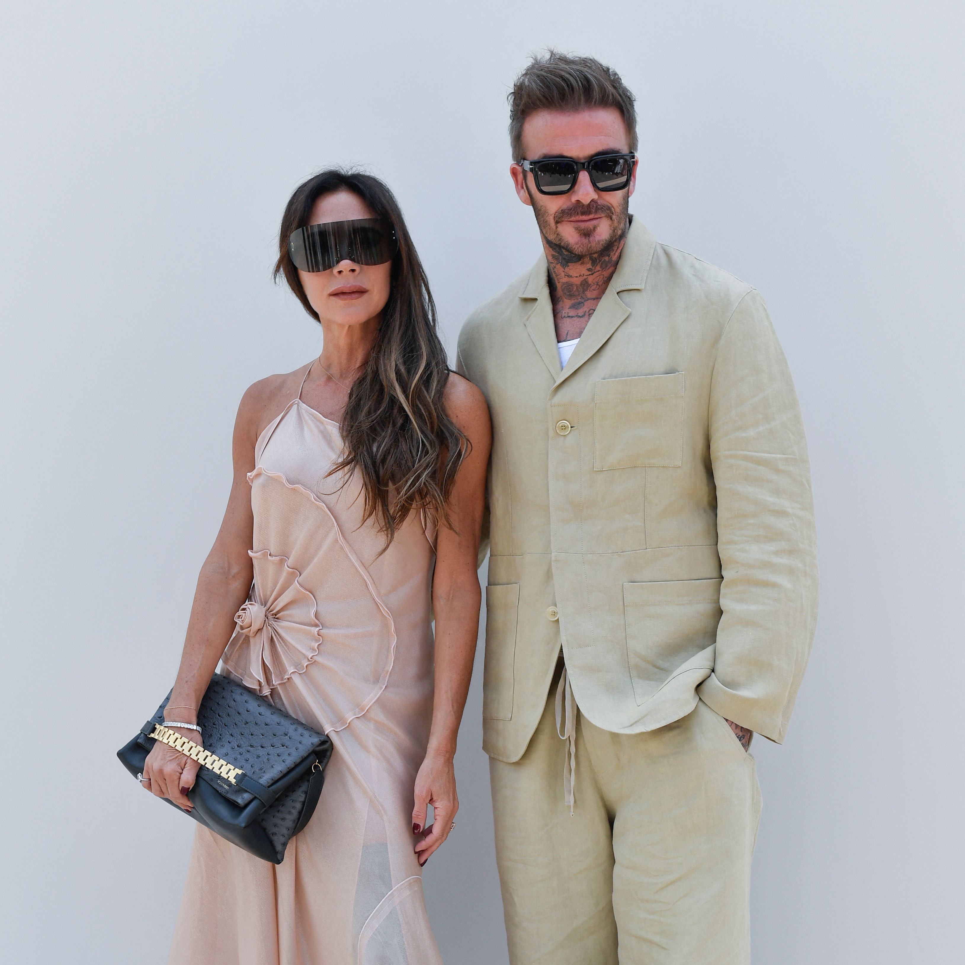 Victoria Beckham elegante con vestido lencero transparente y botas peep toe en Versalles