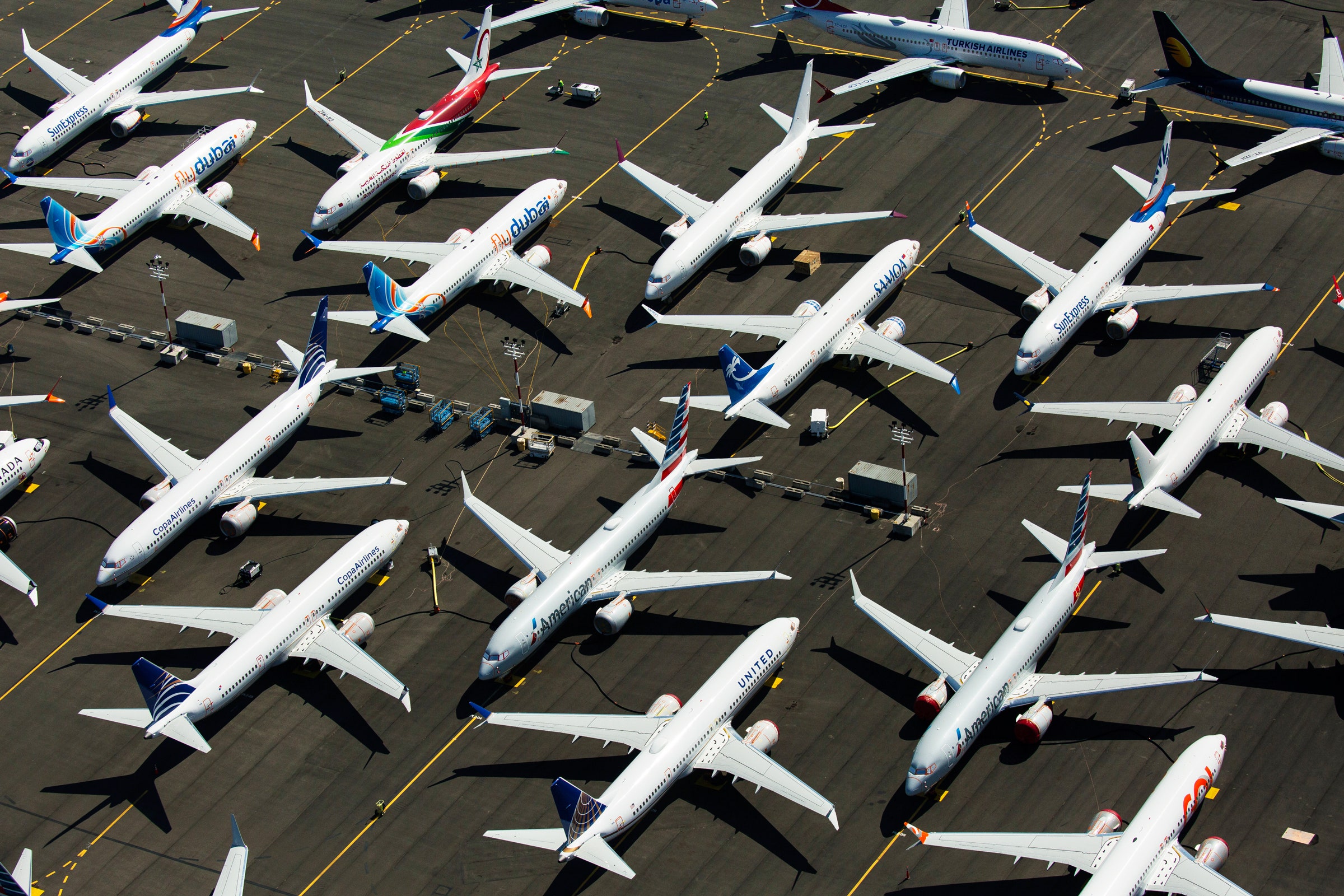 multiple boeing planes sitting in a lot at headquarters