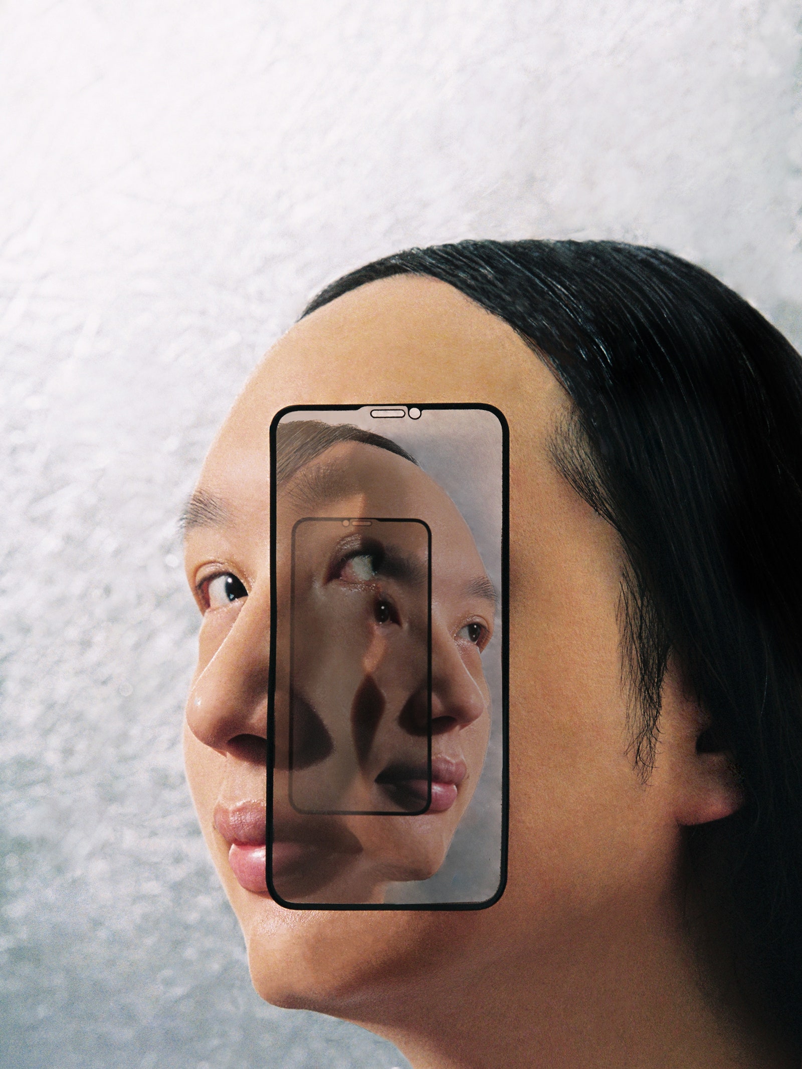 Portrait of Audrey Tang with an infinitymirrorstyle portrait of her face with the same phone case attached to her face.