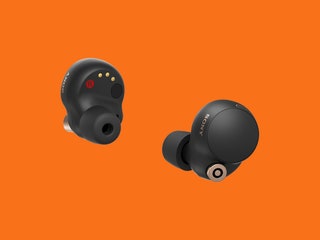 Sony WF1000XM4 earbuds on orange background