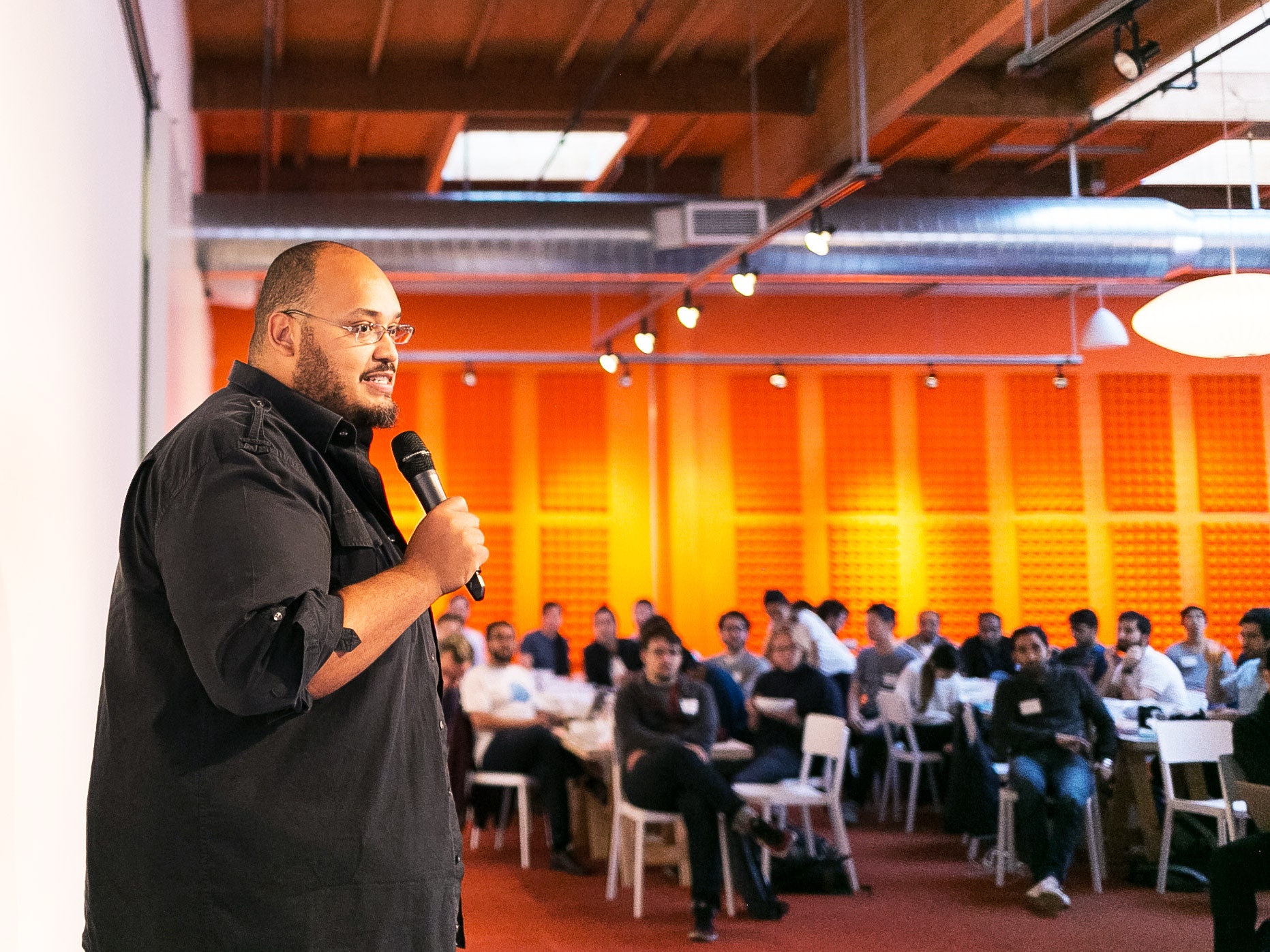 Y Combinator CEO Michael Seibel speaking in front of a crowd of people