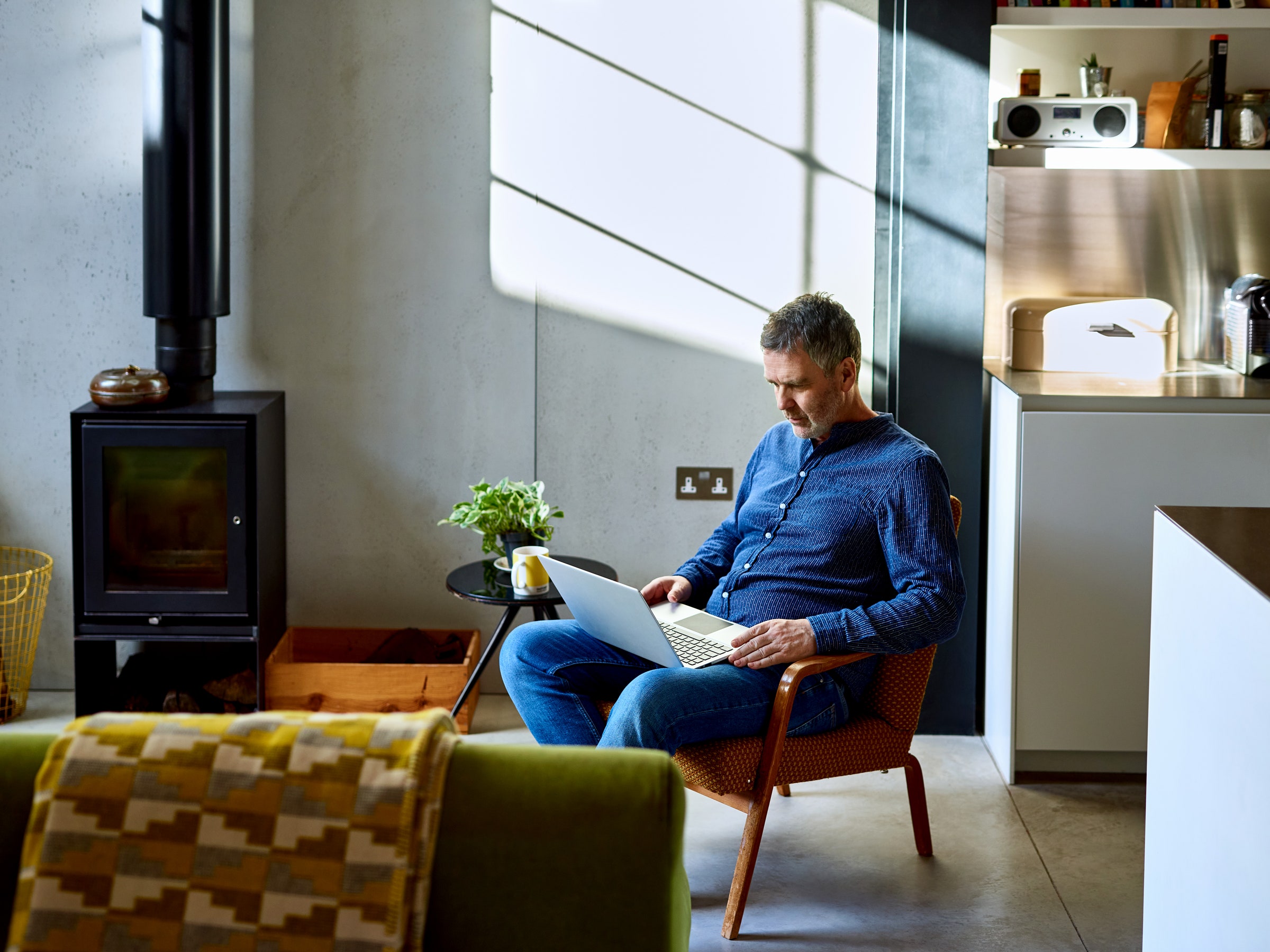 Man working on laptop in living room