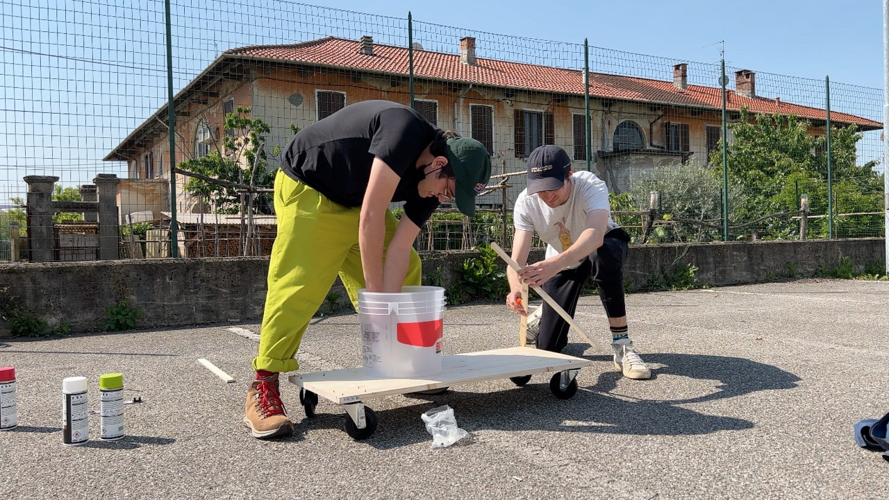 Two people assembling a gokart