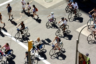 Overhead view of group of cyclists riding on street