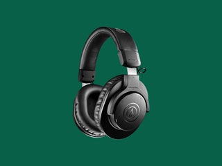 AudioTechnica ATHM20xBT headphones on green backdrop