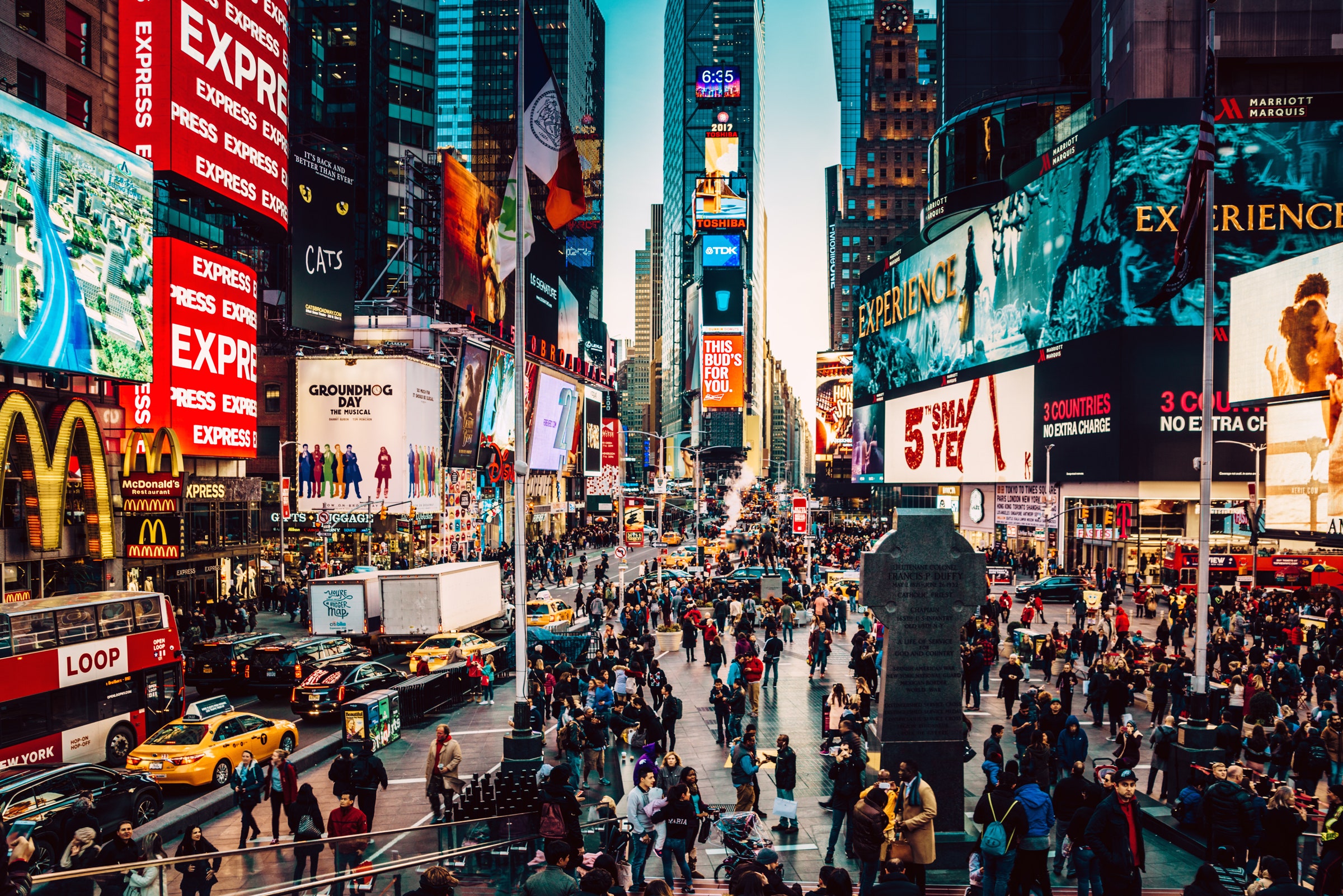 Manhattan's iconic Times Square filled with people and cars at night