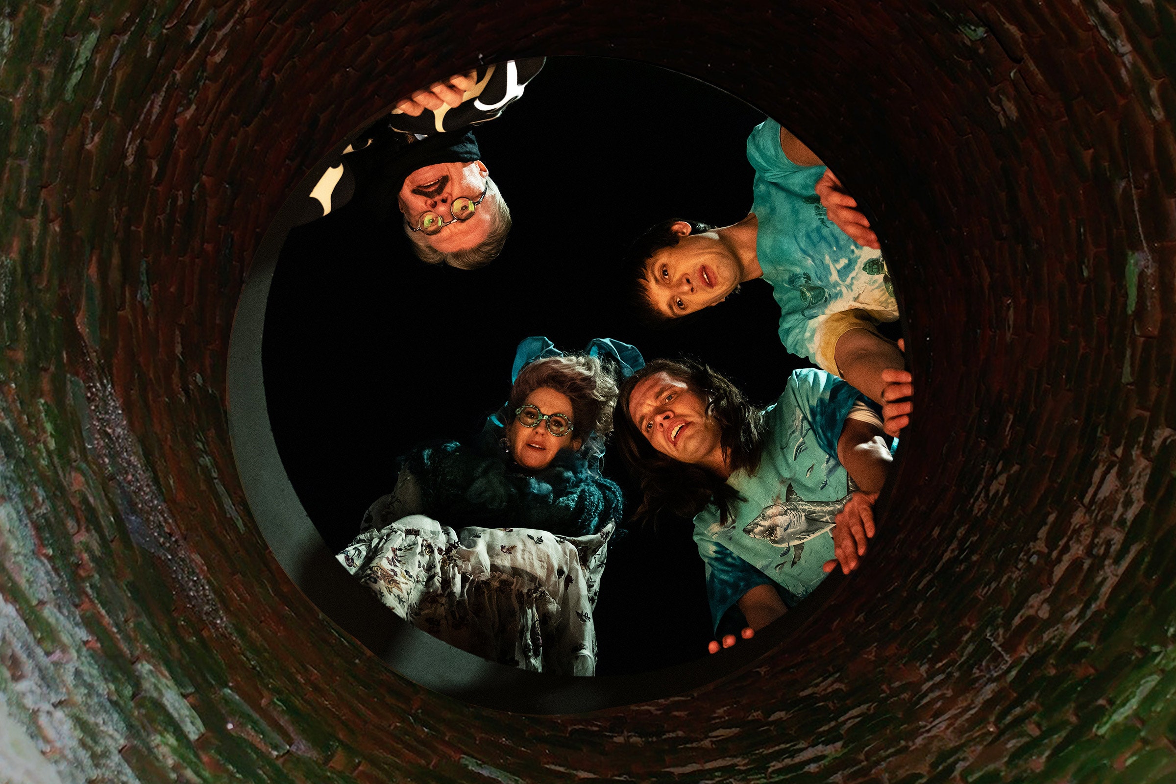 Nathan Lane Megan Mullally Aaron Jackson Josh Sharp looking into a sewer hole