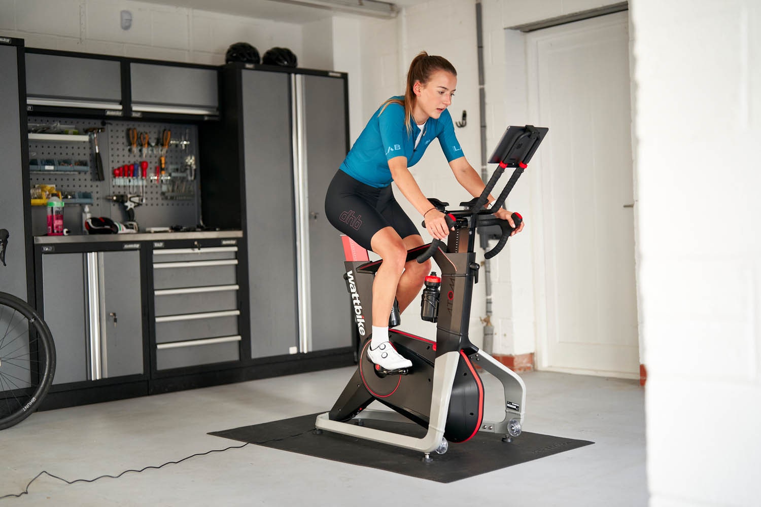 Person riding the WattBike Atom in a garage