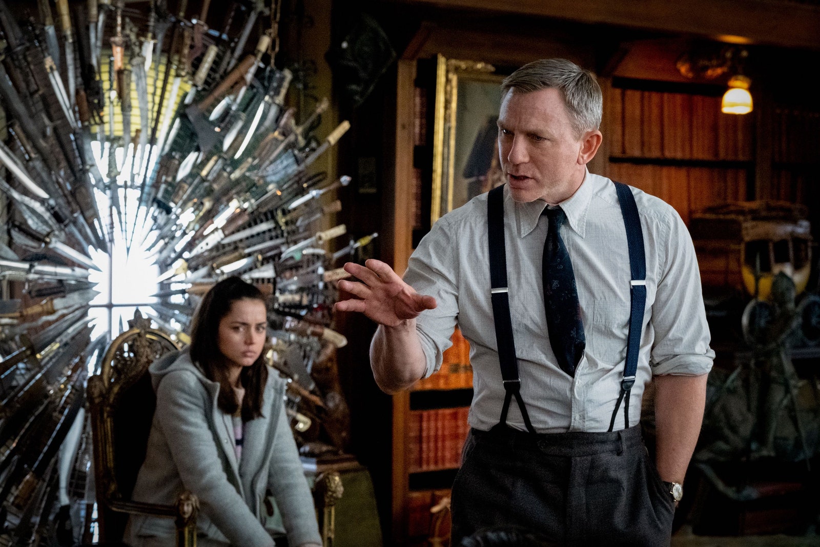 Image may contain Daniel Craig Ana de Armas Accessories Formal Wear Tie Adult Person Clothing Suspenders and Chair