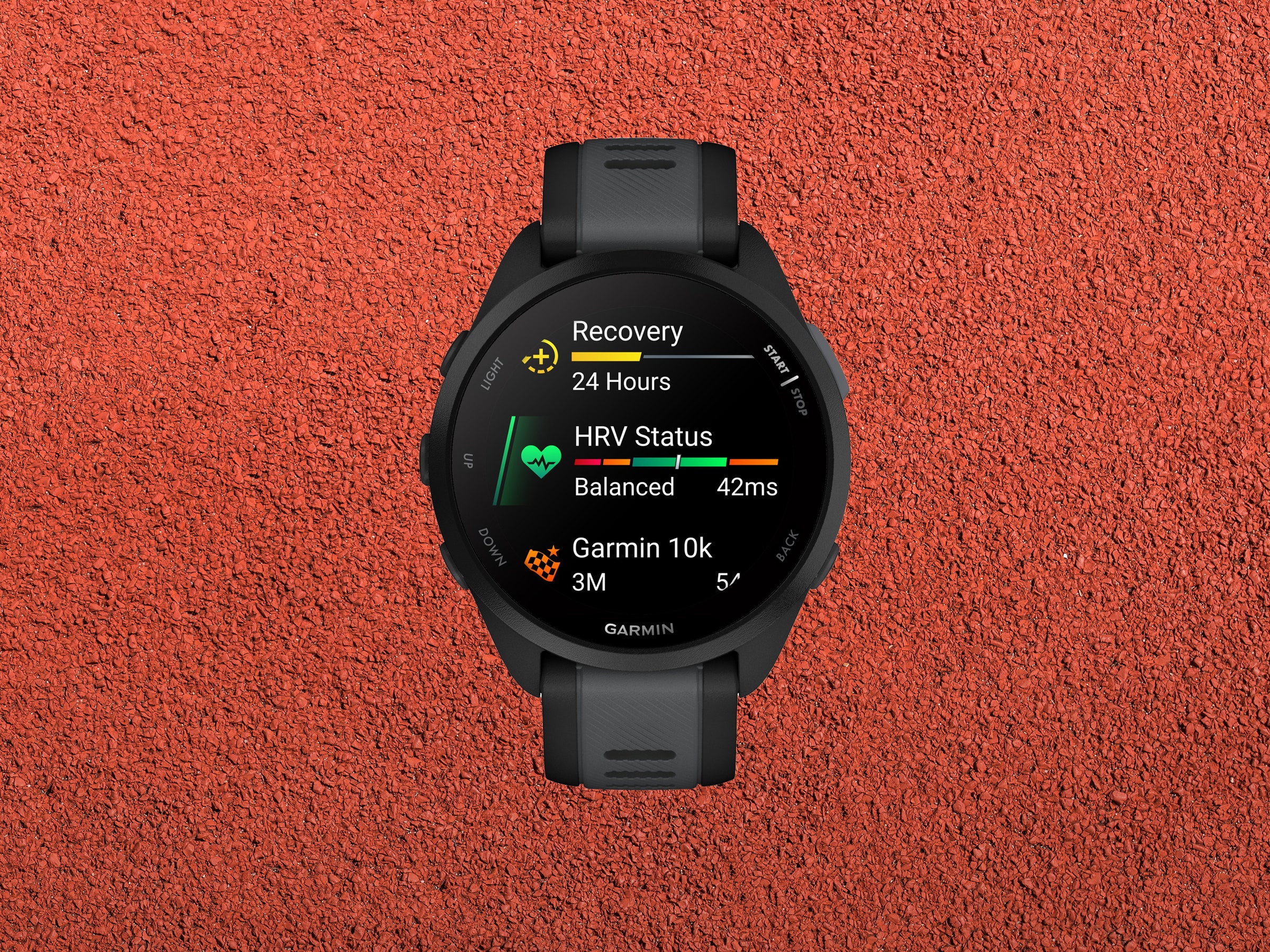 Digital wristwatch with screen showing stats for recovery HRV and distance covered on red rubber background