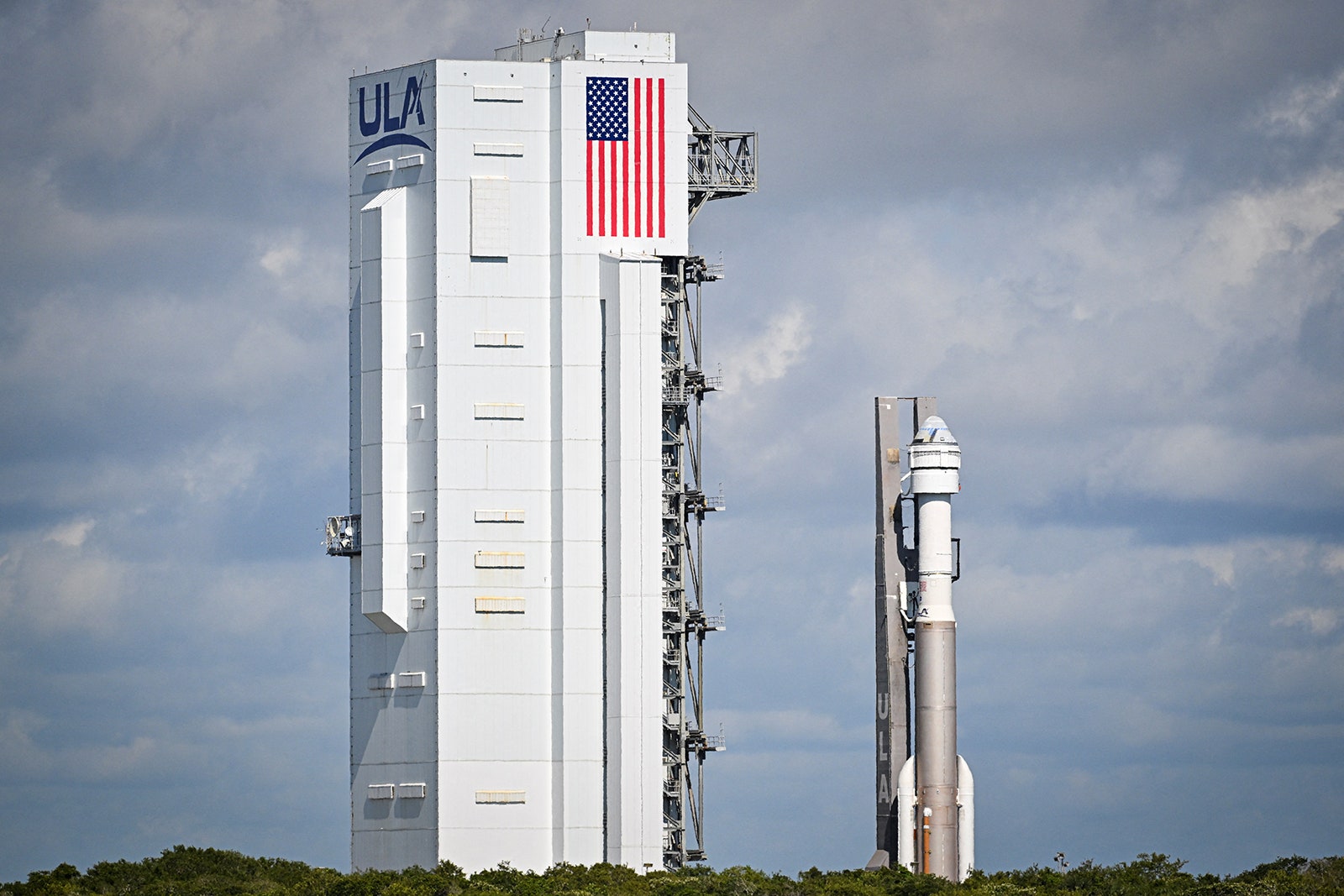 Photo of  The United Launch Alliance  Atlas V rocket is transported to Space Launch Complex 41 at Cape Canaveral Space...