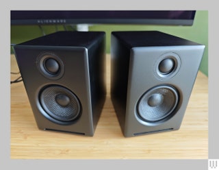 2 small black squareshaped speakers