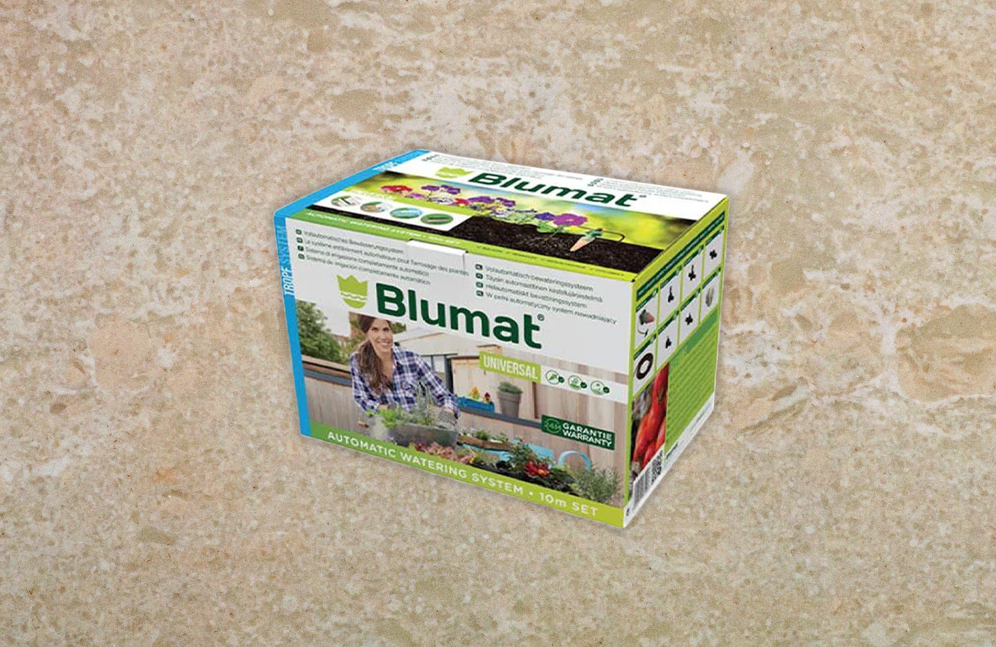 Box packaging of a plant watering system. Background beige marble texture.
