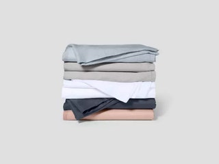 Stack of folded sheets in blue beige white grey and pink