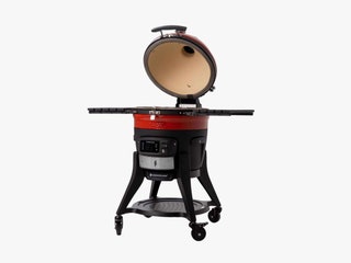 Black and red charcoal grill with the lid open