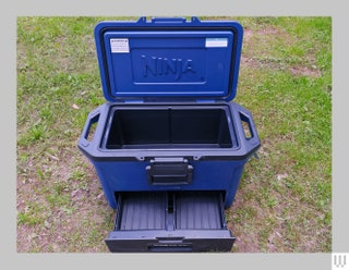 Blue cooler with the lid open and a drawer pulled open at the bottom