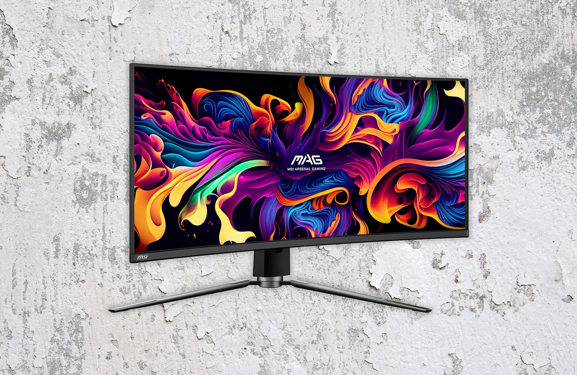 Wide screen monitor with colorful abstract art on the screen. Background white cracked paint on a wall.