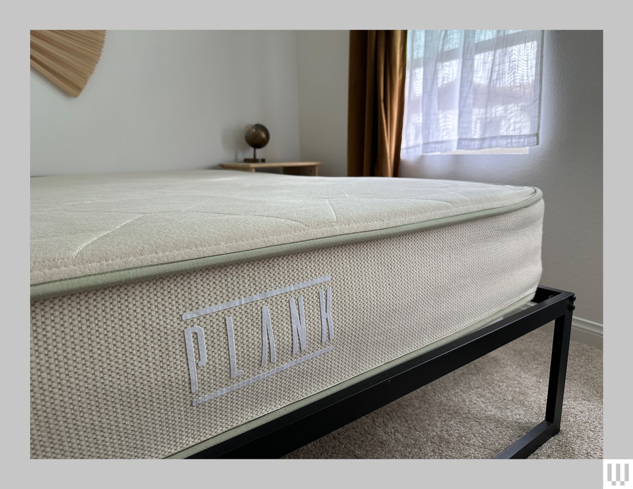 Thick mattress on a minimalist black bedframe