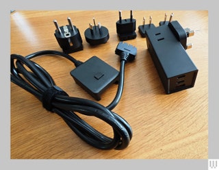 A large electric plug and several adapters