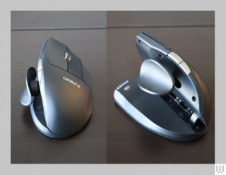 Front and side view or scoopshaped computer mouse with thumb pad on the inner left curve