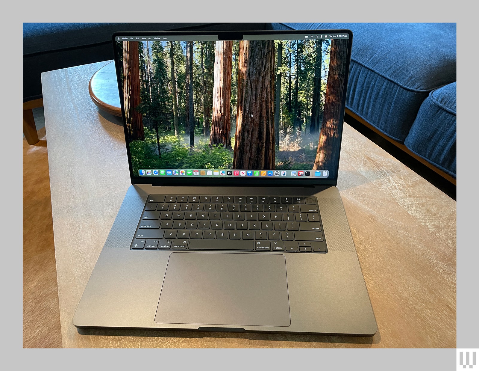 Front view of an open Apple MacBook Pro 16inch 2024 edition a slim dark silver laptop with large screen keyboard and...