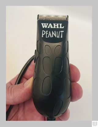 Wahl Black Peanut Clipper and Trimmer held up with a small cord coming from the left side