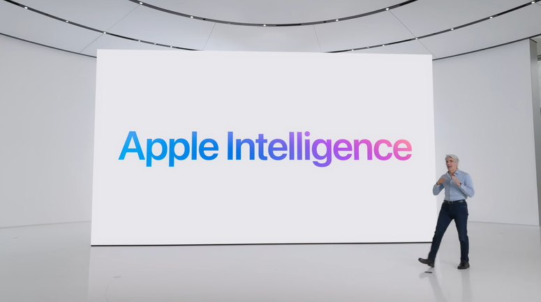 Craig Federighi standing next to a large screen that reads "Apple Intelligence"