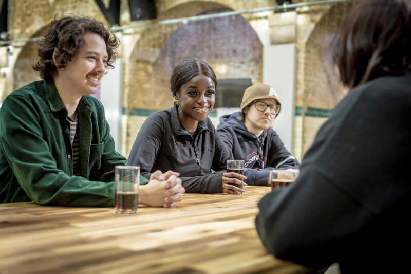 Students having a drink sat at table