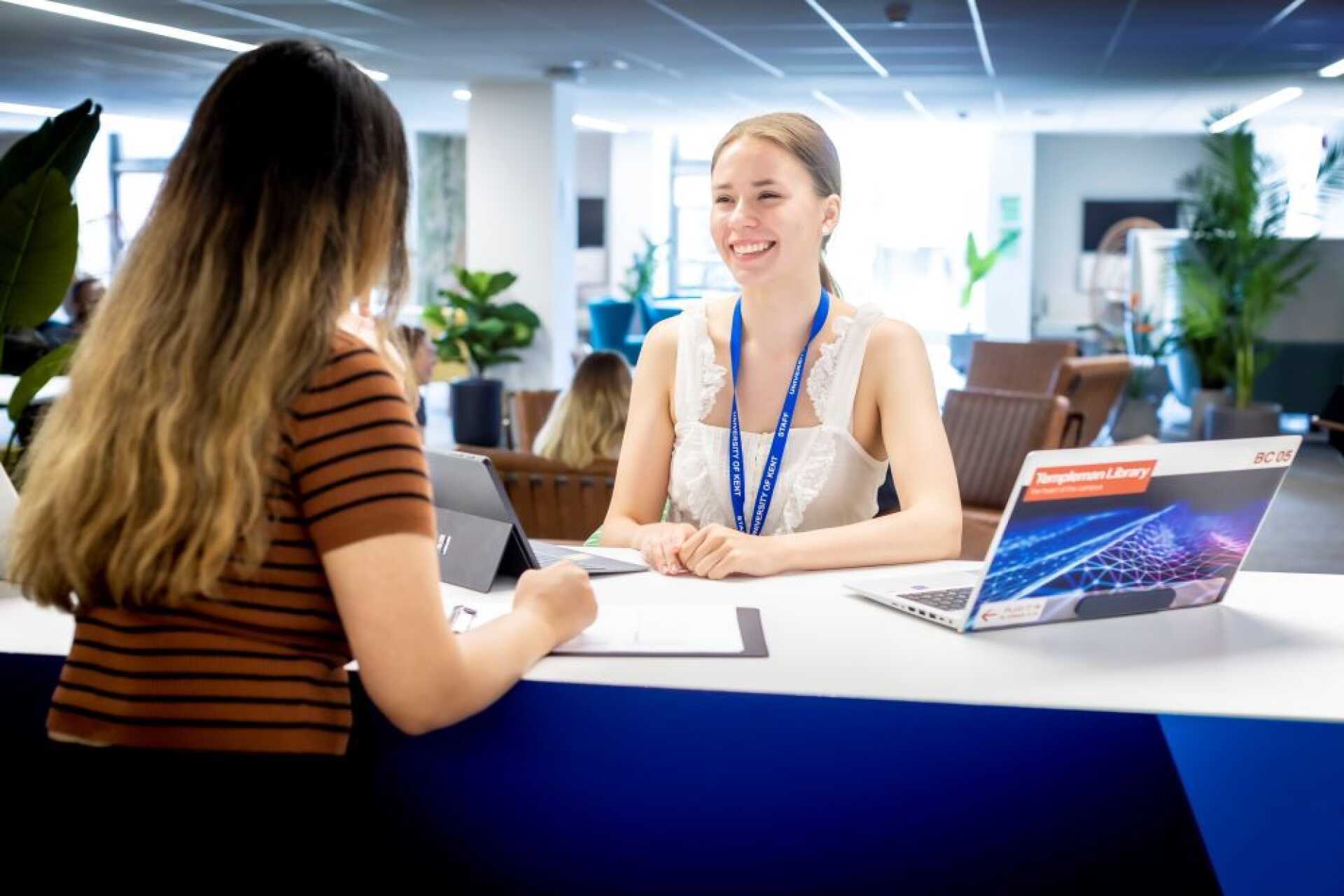 Nexus staff smiling at Nexus Welcome desk