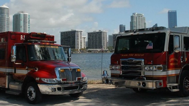 Miami Fire Rescue trucks parked near the water with the cityscape in the background