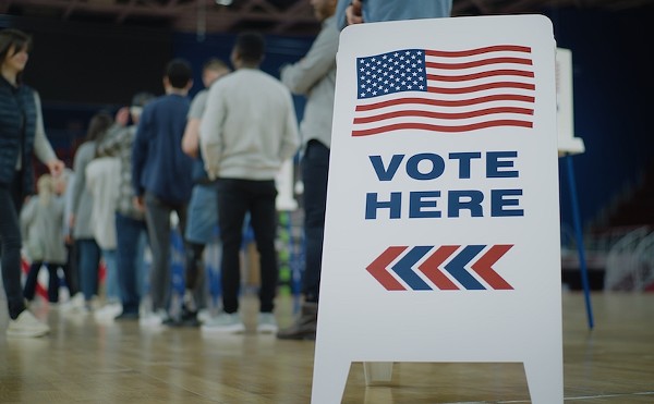 Voters line up to cast ballots at a polling location.