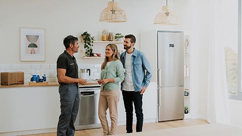 Colourful Bosch Home Service icons in squares floating in an open kitchen next to a stainless steel fridge